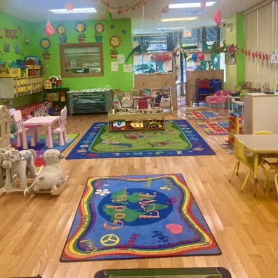 Daycare classroom with play rug and toys at Fantasy Island Chicago