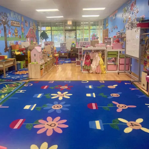 Kindergarten classroom with blue flower rug at Fantasy Island Chicago