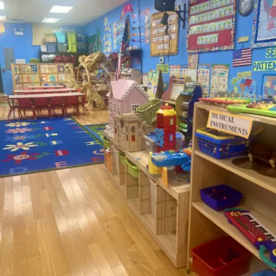 Kindergarten room with toys and colorful carpet