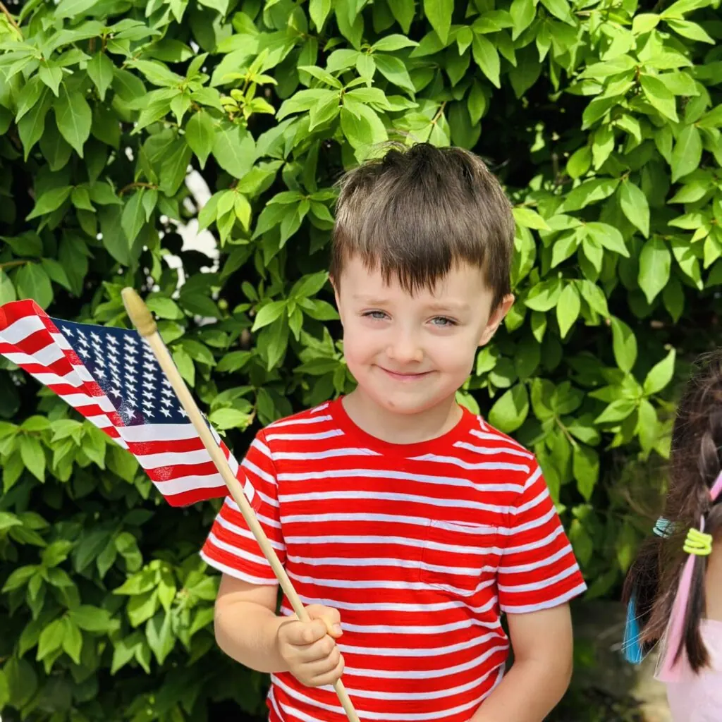 Boy celebrating outdoors at Fantasy Island Schools for Kids, Chicago