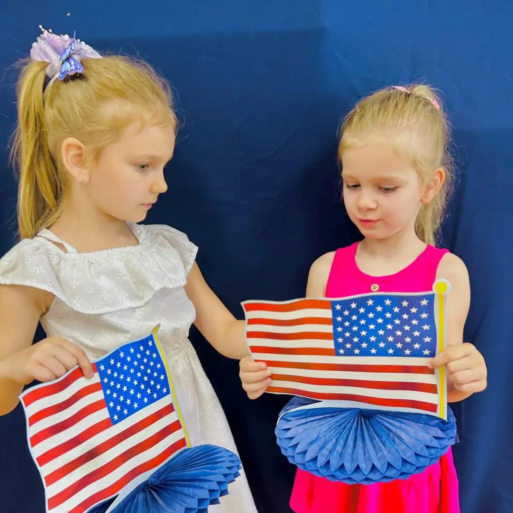 Preschool girls holding handmade flags at Fantasy Island near Niles, IL